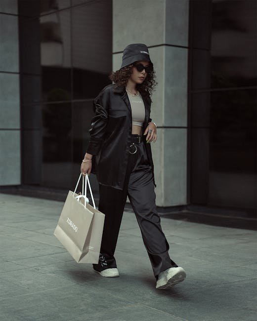 Stylish woman in urban setting with shopping bag showing trendy street fashion.